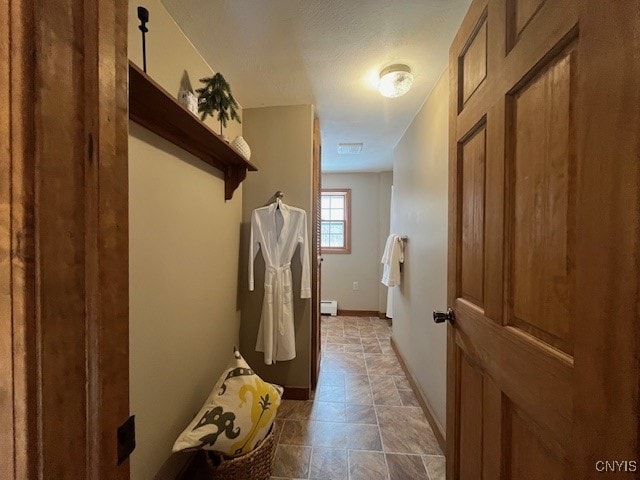 interior space featuring a baseboard heating unit and baseboards