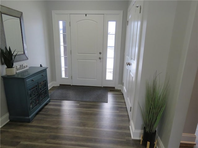 entryway with baseboards and dark wood-type flooring