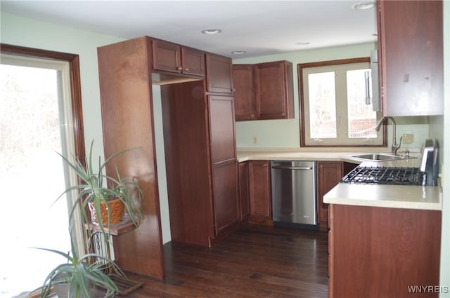 kitchen featuring a sink, light countertops, dishwasher, brown cabinetry, and dark wood finished floors