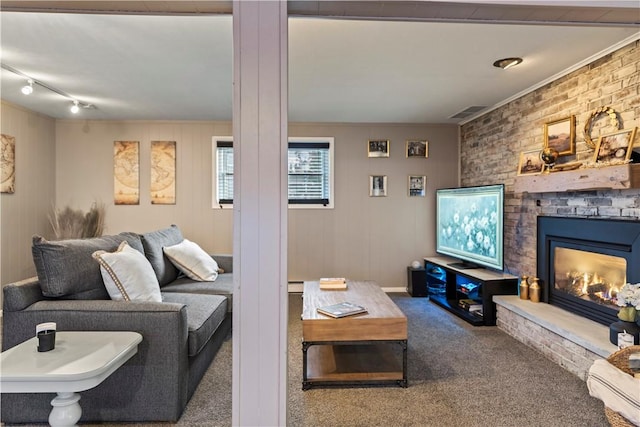 carpeted living area featuring a brick fireplace, visible vents, and a baseboard heating unit