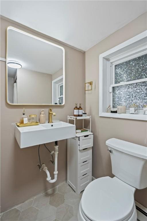 bathroom with toilet and a baseboard radiator