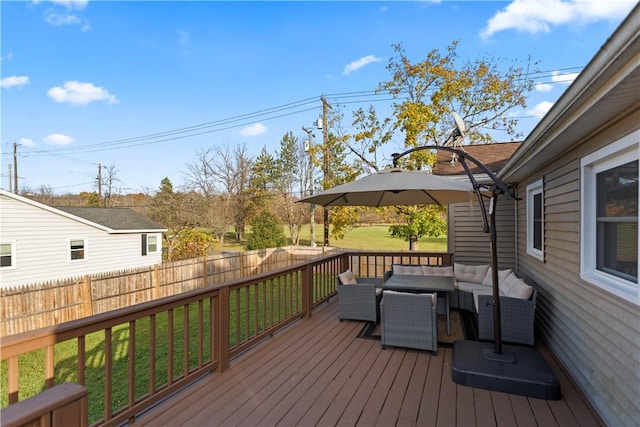 wooden deck featuring a yard, outdoor lounge area, and fence