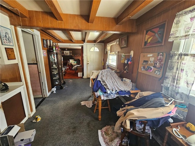 interior space with wood walls and beam ceiling