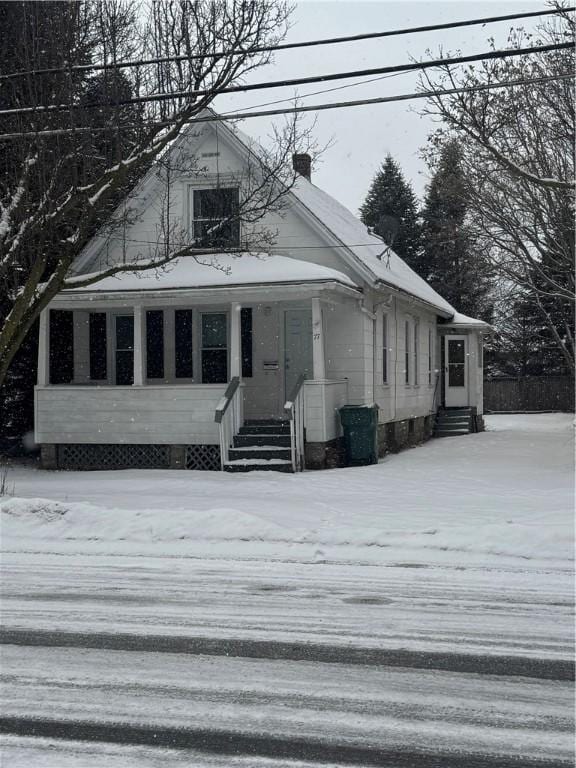 bungalow-style house featuring entry steps and a chimney