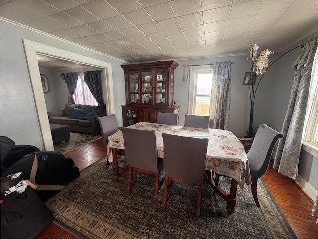 dining area featuring crown molding and wood finished floors