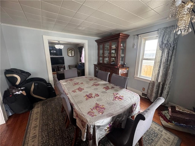 dining area featuring visible vents, crown molding, and wood finished floors