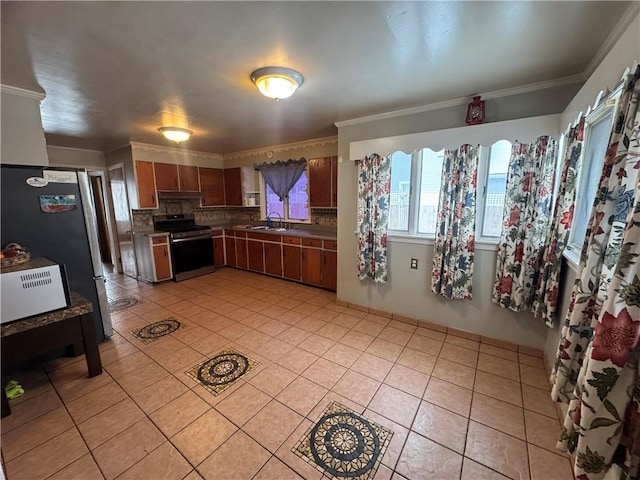 kitchen with light tile patterned floors, under cabinet range hood, stainless steel appliances, and a sink