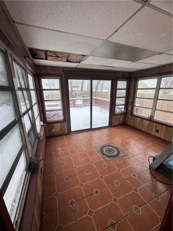 unfurnished sunroom with a drop ceiling