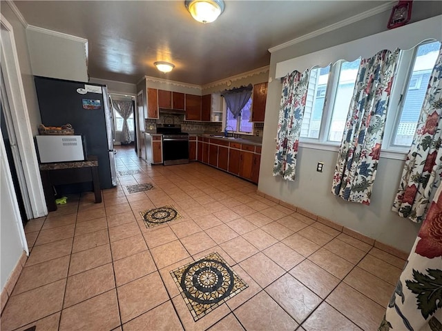 kitchen featuring ornamental molding, a sink, stainless steel appliances, backsplash, and light tile patterned flooring