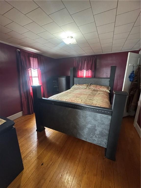 bedroom featuring wood-type flooring and baseboards