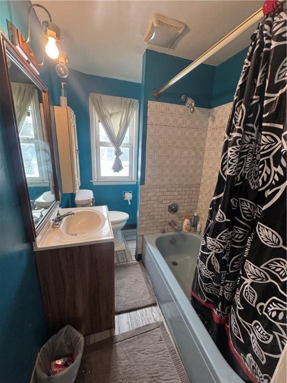 full bathroom with toilet, shower / tub combo, and vanity