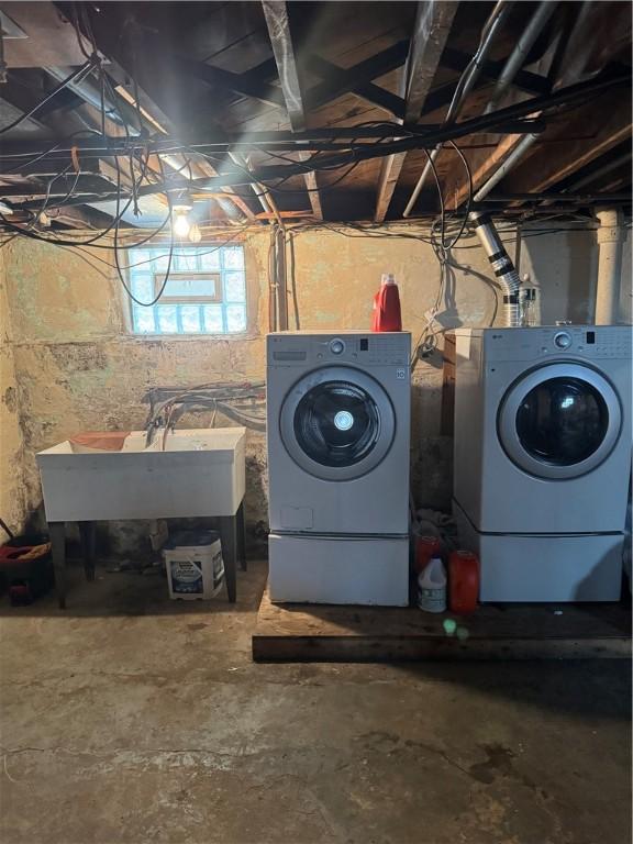 interior space with laundry area, separate washer and dryer, and a sink