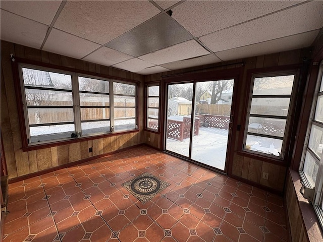 unfurnished sunroom with a paneled ceiling