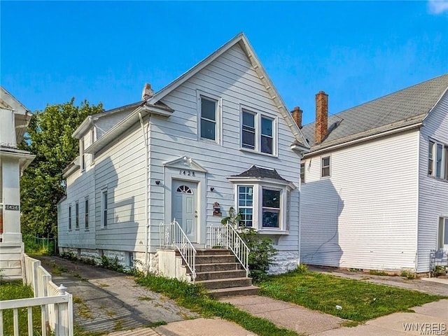 view of front of home featuring fence