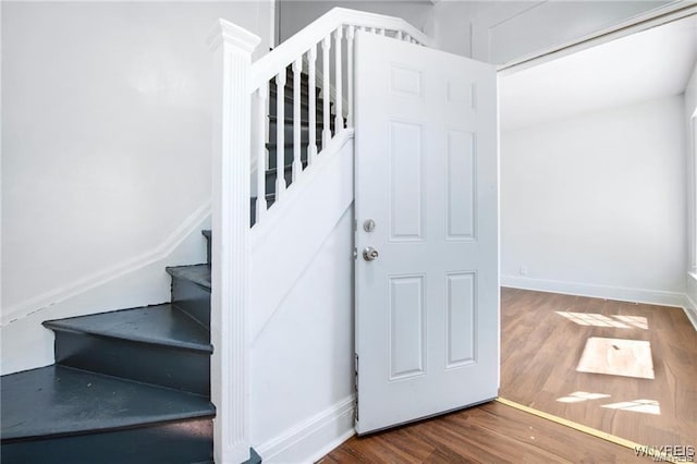 stairs with baseboards and wood finished floors