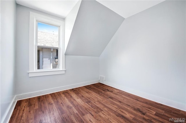 bonus room with vaulted ceiling, wood finished floors, visible vents, and baseboards