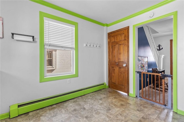 empty room featuring baseboards, a baseboard heating unit, and ornamental molding