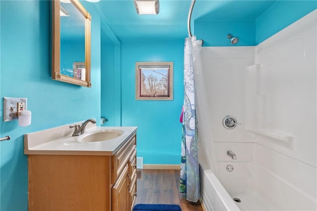 full bathroom featuring visible vents, shower / tub combo with curtain, vanity, and wood finished floors