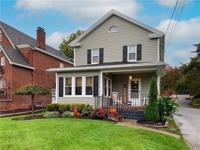 view of front of home with a porch and a front lawn