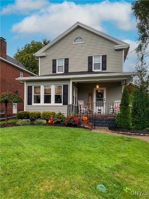 traditional-style home featuring a porch and a front yard