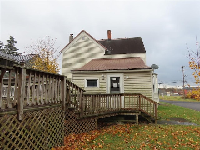 rear view of house with a deck and metal roof