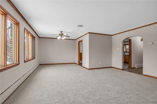 empty room featuring carpet floors, visible vents, a baseboard heating unit, and arched walkways