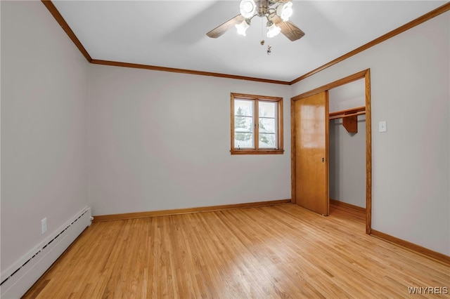 unfurnished bedroom featuring a closet, baseboard heating, light wood-style floors, ornamental molding, and baseboards