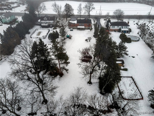 snowy aerial view with a residential view