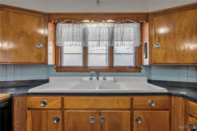 kitchen featuring dishwasher, tasteful backsplash, and brown cabinets