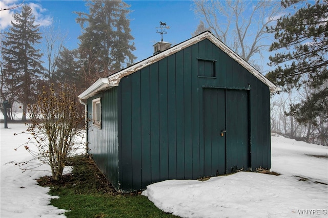 snow covered structure with an outdoor structure