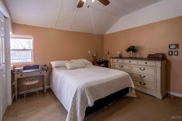 bedroom featuring light carpet, ceiling fan, baseboards, and vaulted ceiling