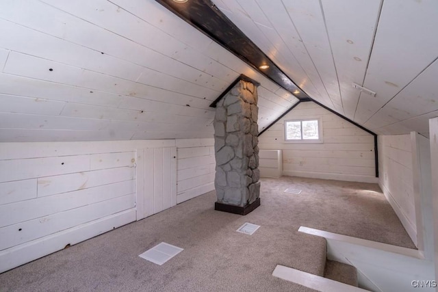 bonus room with carpet floors, wooden ceiling, vaulted ceiling, and wood walls