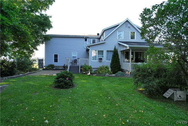 rear view of house with a lawn and cooling unit