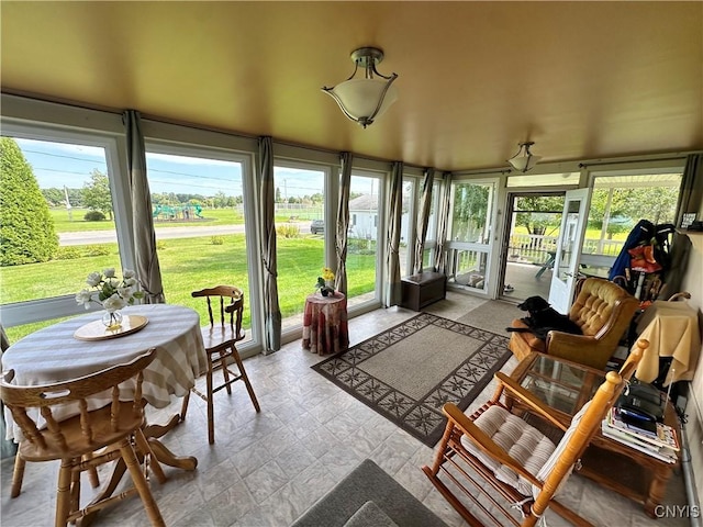 sunroom / solarium featuring a healthy amount of sunlight