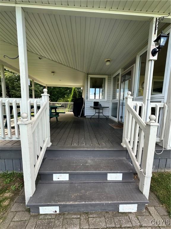 wooden deck with an attached carport