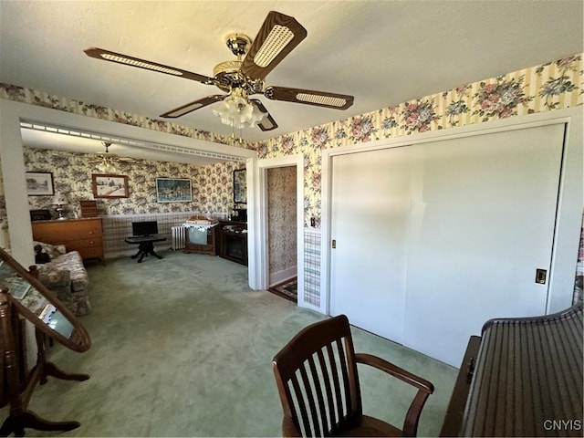 interior space featuring a ceiling fan and wallpapered walls