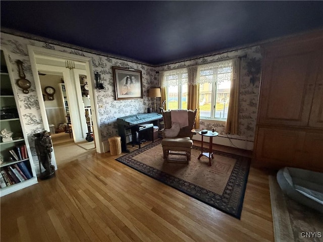 living area featuring wallpapered walls and light wood-style floors