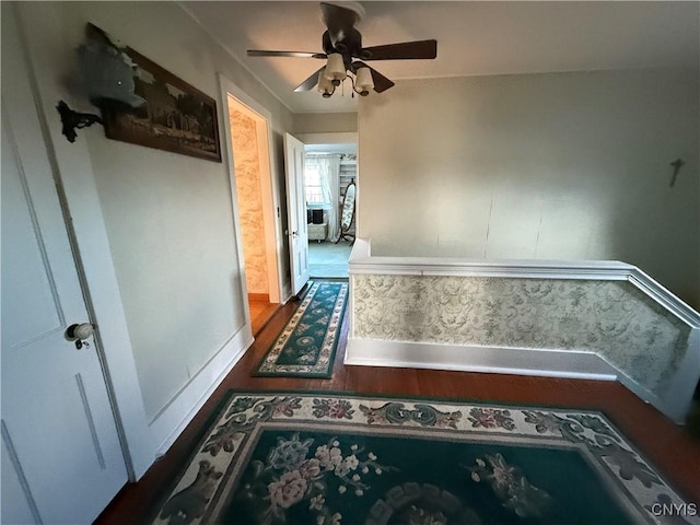 hallway with baseboards and wood finished floors