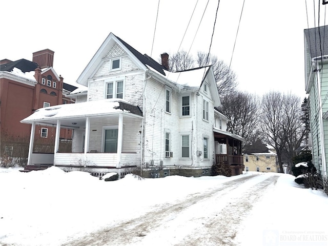 view of front of home with covered porch and a chimney