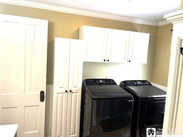 clothes washing area featuring cabinet space, separate washer and dryer, and crown molding