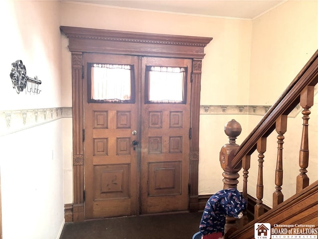 entrance foyer featuring ornamental molding and stairway