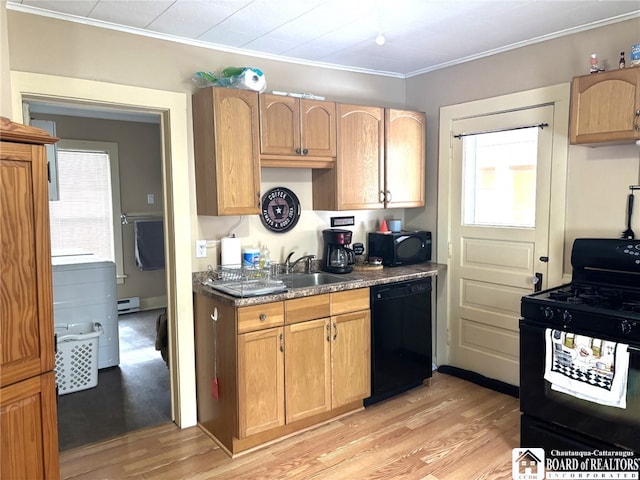 kitchen featuring black appliances, light wood finished floors, and a wealth of natural light