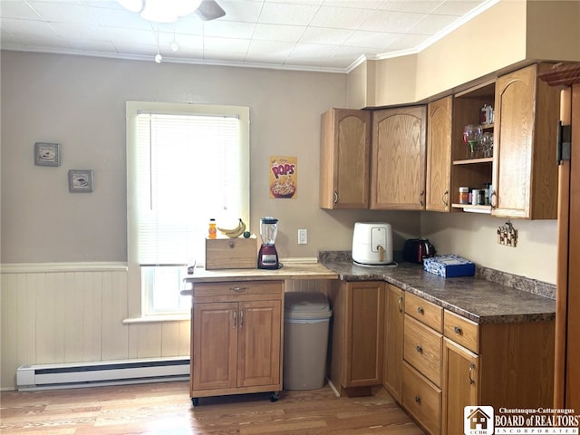 kitchen featuring a wainscoted wall, light wood-style flooring, brown cabinets, baseboard heating, and open shelves