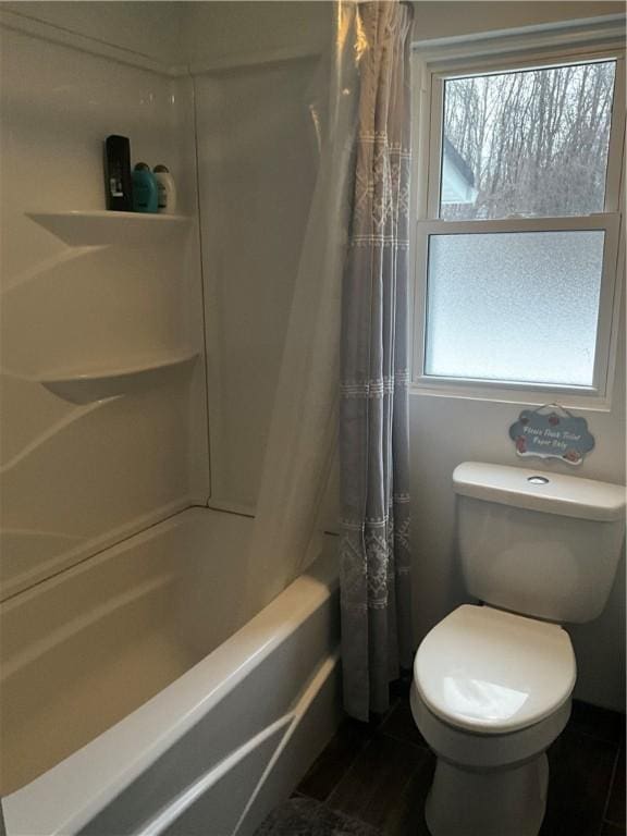 full bath with plenty of natural light, toilet, and shower / bathtub combination with curtain