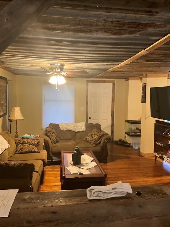 living room featuring ceiling fan and wood finished floors