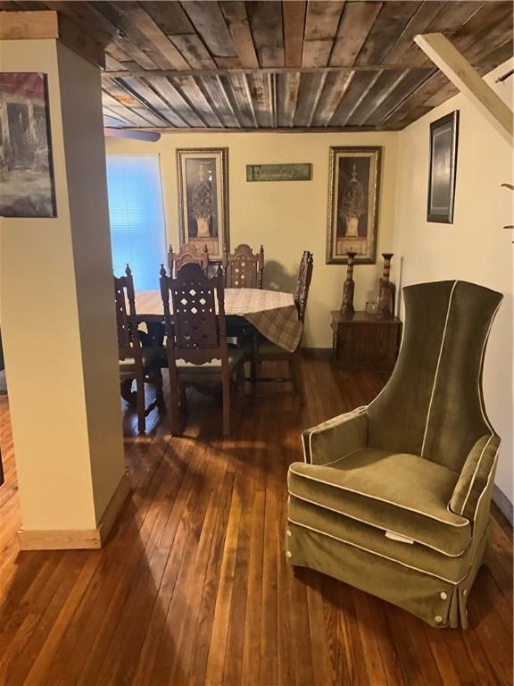 dining room featuring baseboards and hardwood / wood-style flooring