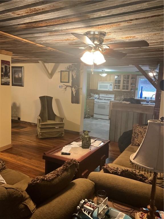 living area with wooden ceiling, ceiling fan, and wood finished floors