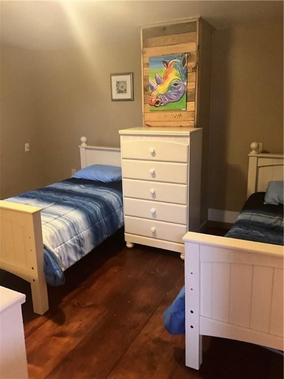 bedroom with dark wood-style floors