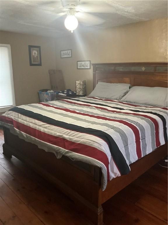 bedroom featuring wood-type flooring and a ceiling fan