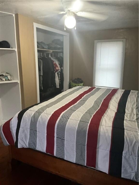 bedroom featuring ceiling fan and a closet